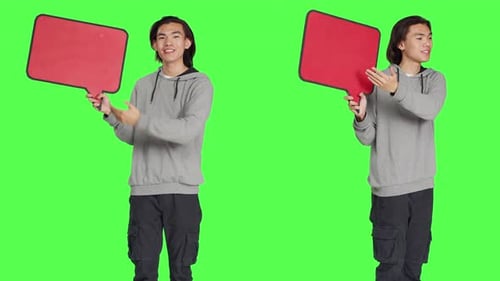 Young Man Holds Speech Bubble in Studio