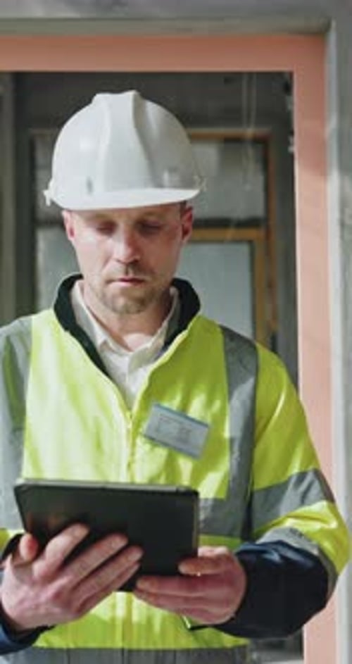 Tablet, man and construction worker on site for inspection for building, renovation or repairs