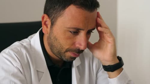 Overworked doctor in his office. Overworked doctor in his office
