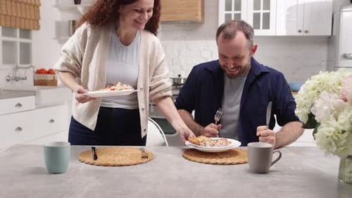 Affectionate Couple Enjoying Meal Together in Kitchen