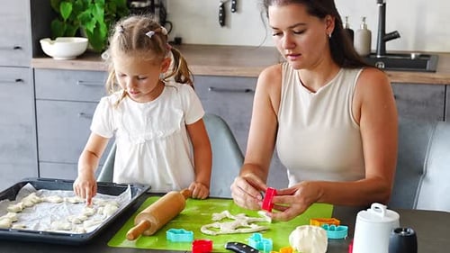 Mother and Child Baking Cookies in Kitchen