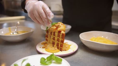 Chef Decorating Piece of Sweet Cake with Mint