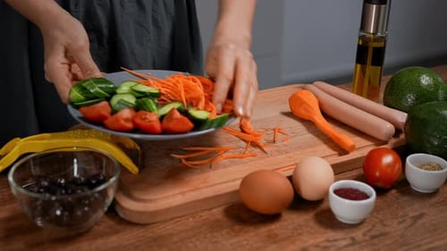 Preparing Healthy Salad with Fresh Vegetables and Sausages
