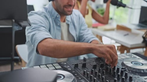 Diverse young stylish audio producer working in the music record studio.