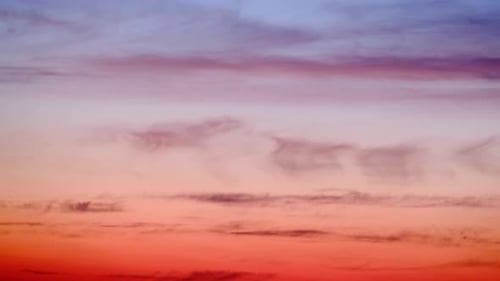 Evening clouds in the sunset sky in the light of the rays of the setting sun. timelapse