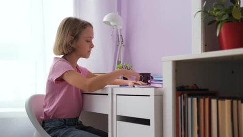 Girl Studying at Desk in her Bedroom