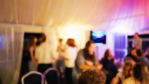 A Lively and Vibrant Party Atmosphere Filled with Colorful Lights and Joyful Guests Celebrating