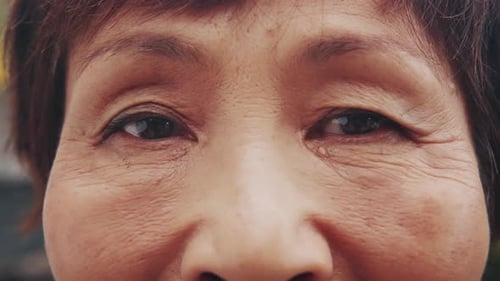 Close-up of Woman's Face with Tear on Cheek