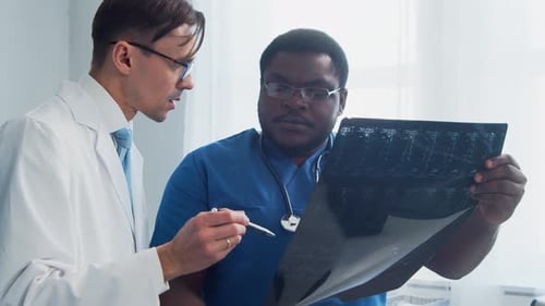 Doctor and Surgeon Talking Near Window Medical Workers in Hospital Office Day Light Healthcare
