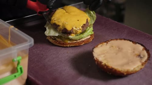 Making Hamburger With Cheese and Lettuce in Restaurant