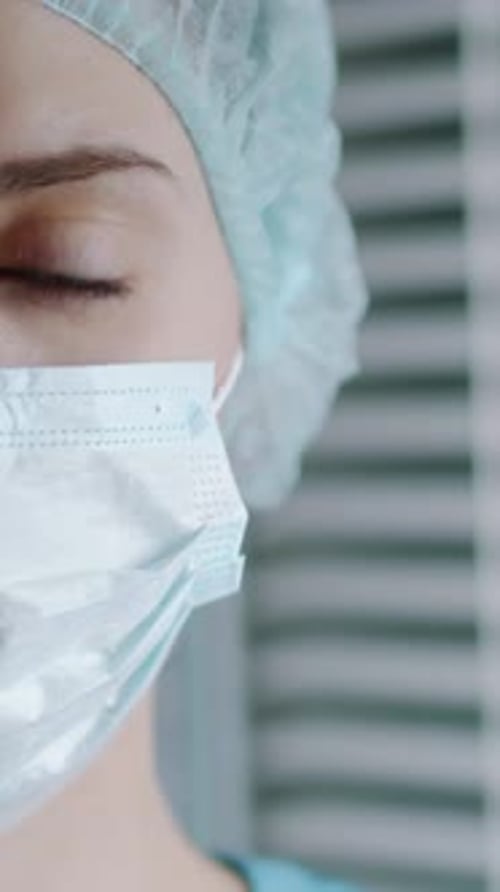 Close-Up of Face of Nurse Wearing Medical Mask and Hair Cap