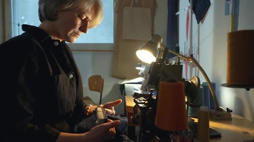 Woman Works at a Sewing Machine in Workshop