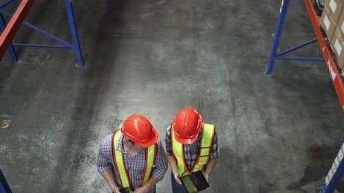 Blue collar workers working at warehouse.