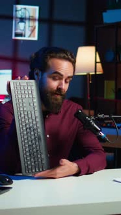 Man Presents Keyboard Product Review in Studio Setting