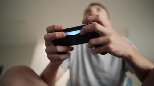 Close Up Caucasian Teenage Boy Holding Wireless Controller in Hands