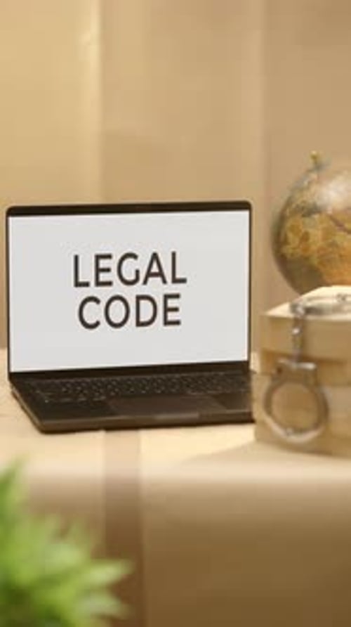 Laptop Screen Displays Legal Code on Desk