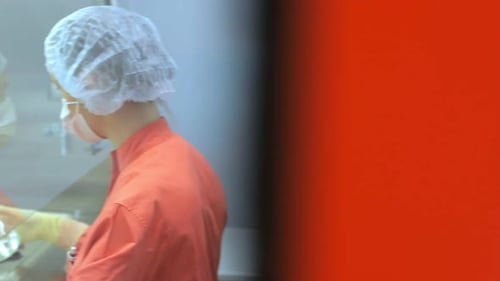 Woman in Protective Gear Works in Laboratory