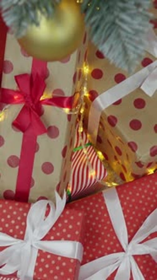 Christmas Gifts Under Tree with Lights and Ornaments