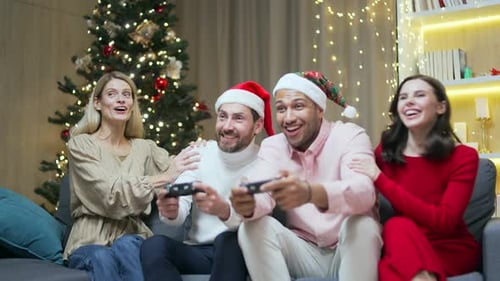 Friends Play Video Games Wearing Holiday Hats