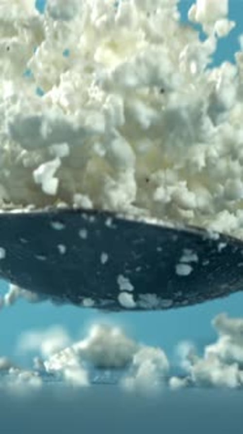 A Spoonful of Fresh Cottage Cheese Falls on the Table Filmed on a Highspeed Camera at 1000 Fps