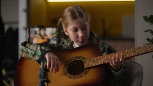 Girl Recording Guitar Lesson for Social Media
