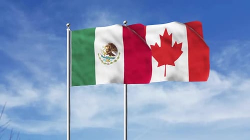 Flags of Mexico and Canada Waving in Blue Sky