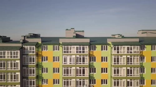 Aerial Footage of a Tall Residential Apartment Building with Many Windows and Balconies