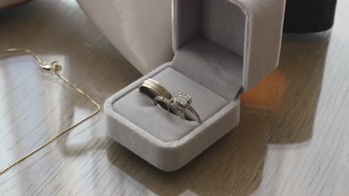 Elegant Wedding Rings in Box with Gold Necklace