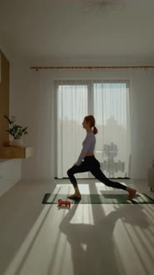 Woman Practicing Yoga in a Sunlit Room