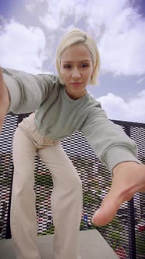 Stylish Woman Posing on Rooftop with Fashionable Outfit