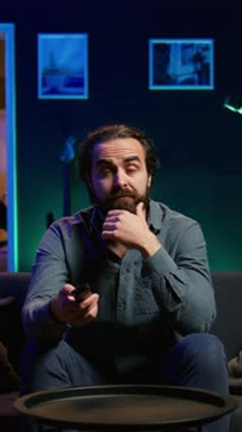 Man Watching Television in Dark Living Room