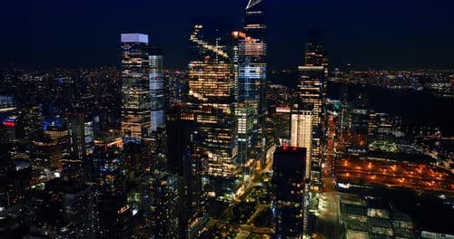 Rising to the tops of magnificent skyscrapers. Amazing New York full of lights at night.