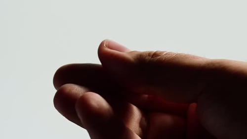Hand Opening Slowly Against White Background Close Up