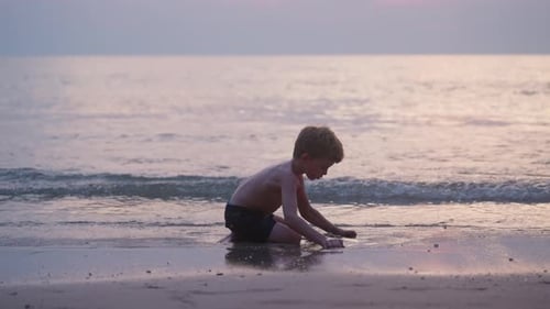 Child Playing at the Beach at Sunset