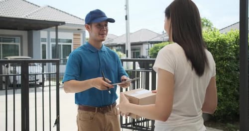 Delivery service male in uniform give cardboard box package to receiver customer client front