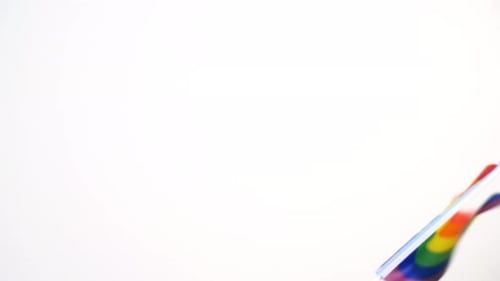Pride flag waving against a white background