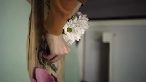 Florist Crafting Bouquet. Florist at Work. Florist makes bouquet in flower shop Lera Vertical