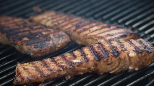 Salmon Grilling on Hot Outdoor Grill Close Up