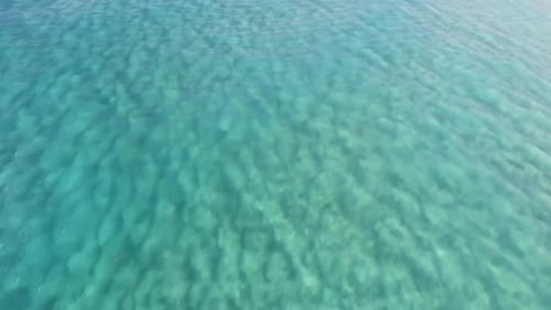 Aerial footage of a perfectly crystal clear blue turquoise water in a tropical paradise. Beautiful h
