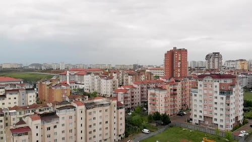 Aerial city view with apartments houses and traffic on the roads on a winter day. Onurkent, Shehzada