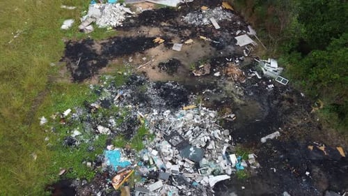 Pile of trash on a beautiful green field