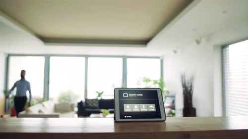 Man Walks Past Smart Home Tablet Interface