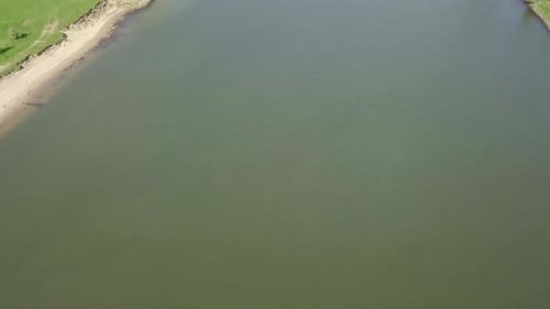 aerial footage of the boat passing on the big river or canal in Holland