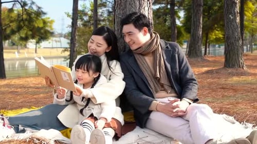 Happy family in the outdoor outing having a picnic in the park, concept of destination, family trave