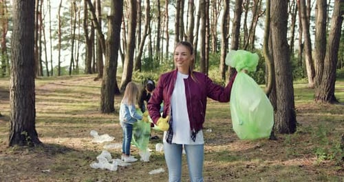 People Cleaning Up Litter in a Forest