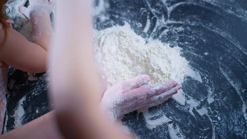Mother and Children Make a Heart Out of Flour with Their Hands