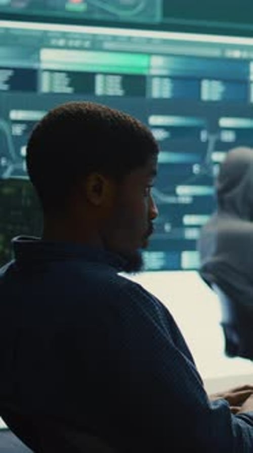 Man Types at Computer in Technology Workplace