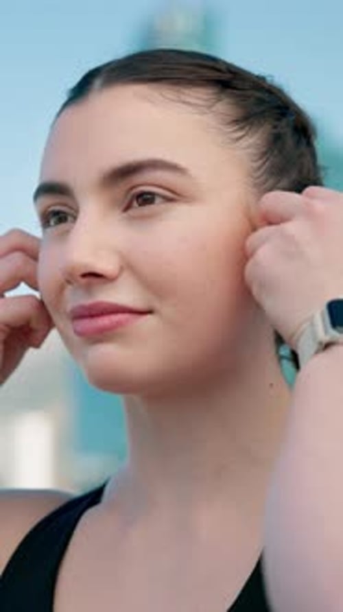City, athlete and woman with earphones on break, fitness or rest after workout for health and music