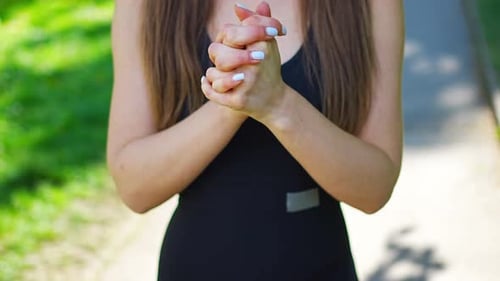Young Woman in Black Sportswear is Doing Hand Warmup Exercises in City Park Outdoor Sports Training