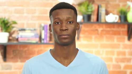 Portrait of a young man looking at camera